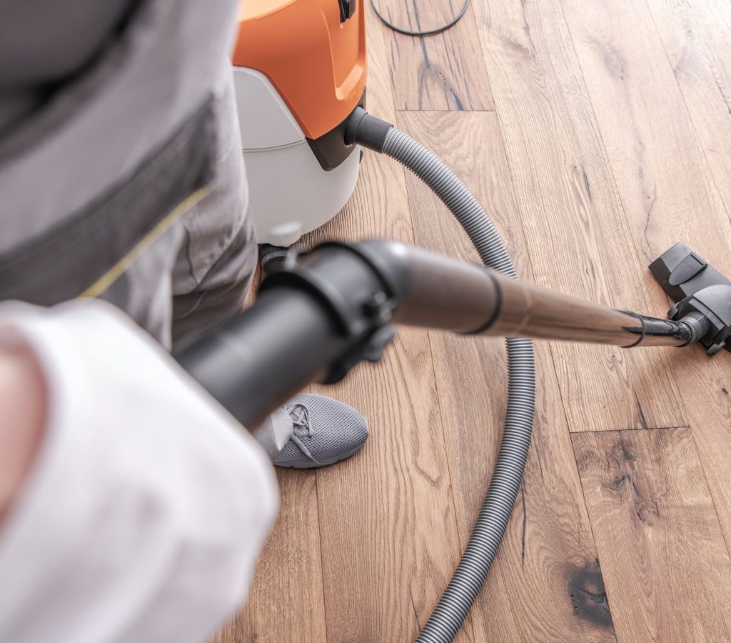 male-worker-vacuuming-hardwood-flooring-.jpg male-worker-vacuuming-hardwood-flooring-.jpg